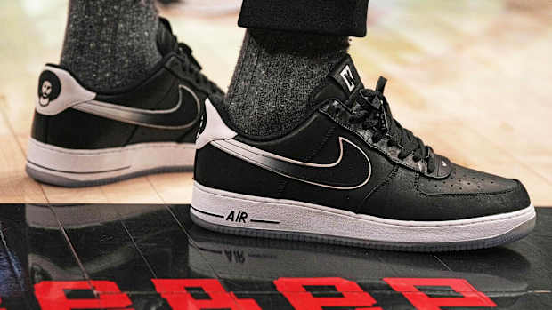 View of black and white Nike Air Force shoes.